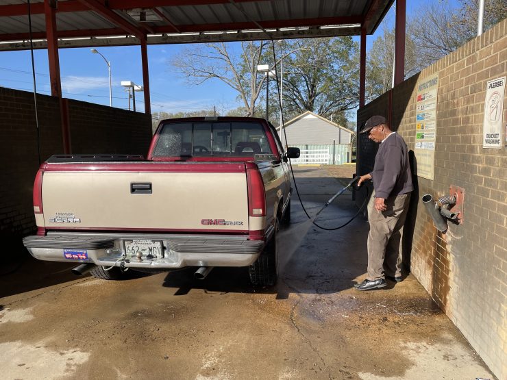 Tommy Tate washes his truck in the town of Mason, on the edge of the Blue Oval City.