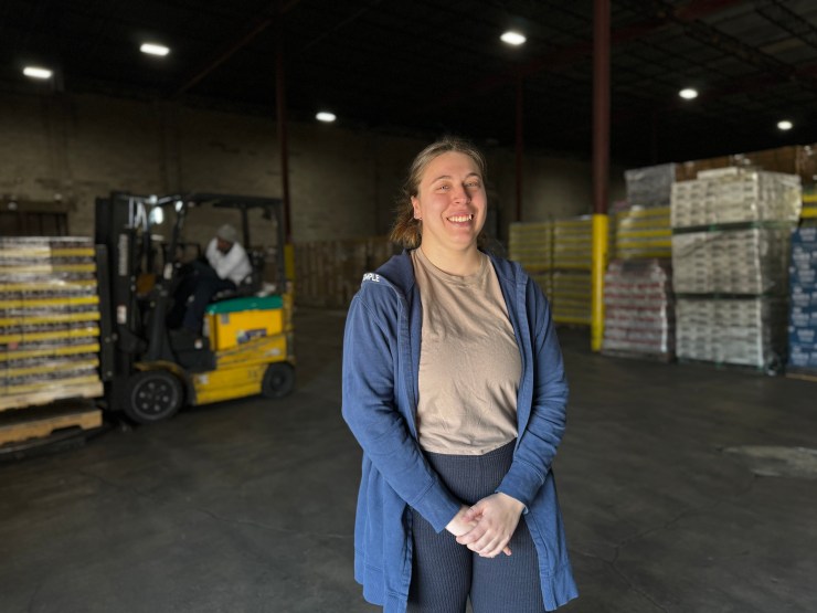 Shannon Monaghan smiles in the warehouse