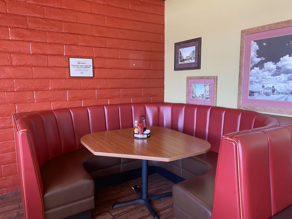 A red curved booth in a Denny's restaurant. 