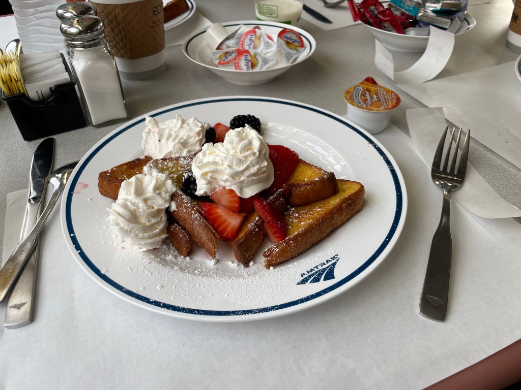 A plate of French toast on an Amtrak logo plate.