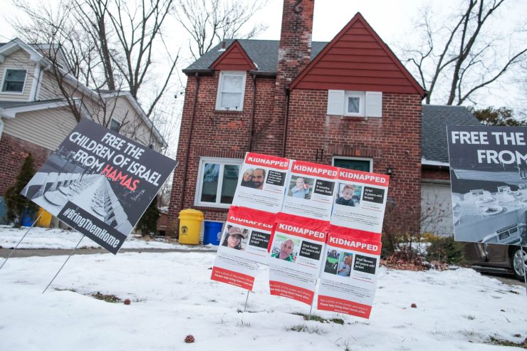 Posters demanding the release of Israeli hostages outside a home .